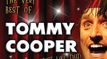 The Very Best of Tommy Cooper title, in front of red curtains and his face to the right wearing a red hat