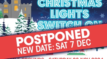 Christmas lights banner with a red banner across saying postponed and the new date